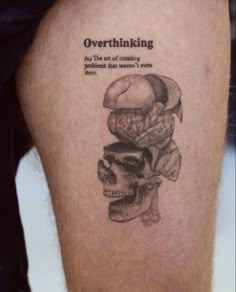 a person with a tattoo on their leg that says overthinking, the art of craning