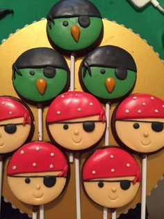 there are many decorated cookies on the stick in the shape of pirate faces and beaks