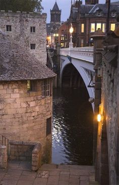 a river running through a city next to tall buildings