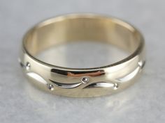 So lovely! This vintage piece is in the cigar band style, with a dotted lined pattern wrapping the ring, worn alone or against an engagement piece, this piece is sweet and timeless! Metal: 14K Yellow and White Gold Width of Band: 4.3 mm Height off Finger: 1.4 mm Ring Size: 4.50 Marks: "ARTCARVED{14KT" Stamped on the inside band Heirloom 14k Gold Band With Diamond Cut, Heirloom 14k Gold Diamond Cut Band, Heirloom Jewelry With Decorative Band, Formal Rings With Decorative Wide Band, Anniversary Yellow Gold Band With Decorative Detail, Anniversary Yellow Gold Decorative Band, Elegant Engraved Ring With Thick Decorative Band, Elegant 14k Stamped Band Jewelry, Heirloom Diamond Ring With Decorative Band For Formal Occasions