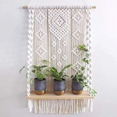 macrame wall hanging with three potted plants