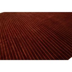 a red and brown striped rug on top of a white floor