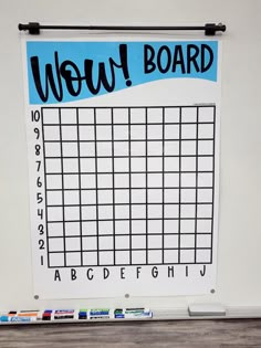 a white board with black and blue writing on it that says woww board next to some crayons