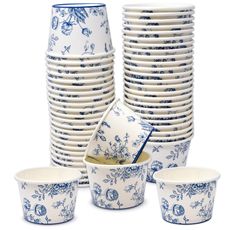 a stack of blue and white dishes sitting next to each other