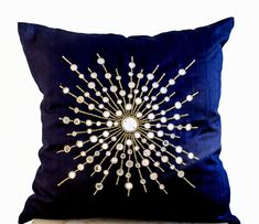 a blue pillow with white beads on it