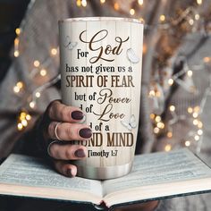 a woman is holding a book and coffee cup with the words, for god has not given us a spirit of fear but of power