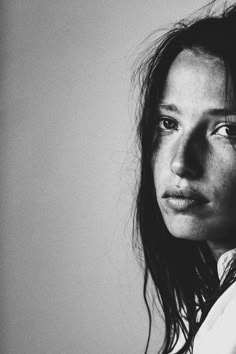 a black and white photo of a woman with frizzy hair