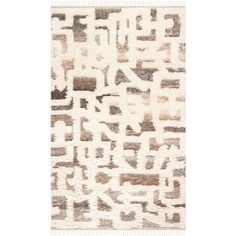 a beige and white rug with an abstract design