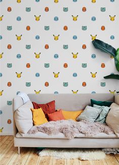 a couch sitting in front of a wall with pokemon wallpaper