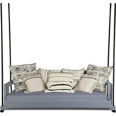 a gray swing bed with pillows and throw pillows on the bottom, along with a white background