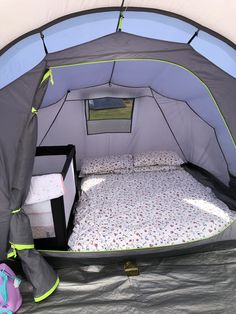 a small tent with a bed inside of it