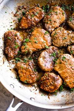 the meatballs are being cooked in the skillet on the stove top and ready to be eaten