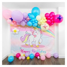 an image of a birthday party with balloons and unicorns on the wall behind it