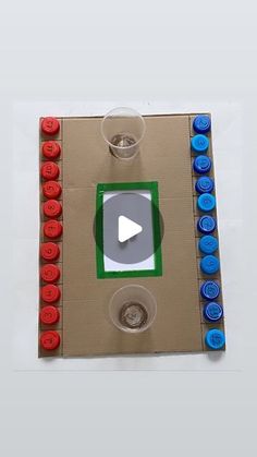 a cardboard board with buttons and a video game on the front, as seen from above