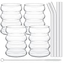 a set of six clear glass drinking glasses with straws next to eachother