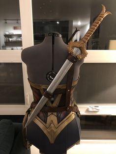 a cosplayed costume with two swords on display