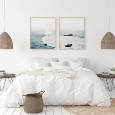 a bedroom with two pictures hanging above the bed