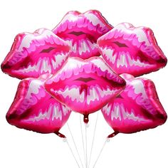 a bunch of pink lips balloons floating in the air