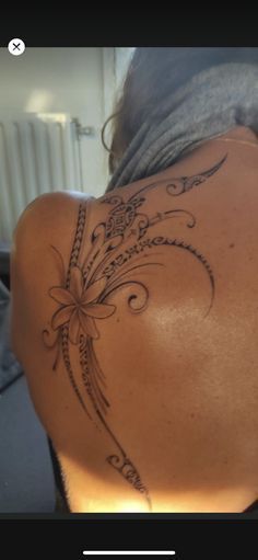 the back of a woman's neck with tattoos on it