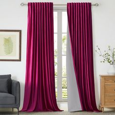 a living room with white walls and pink curtains