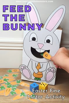 a person holding a pencil in front of a paper bunny