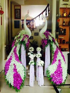 two large white and purple flowers are in front of some peacocks with long necks