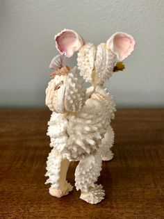 a figurine of a sheep on a wooden table