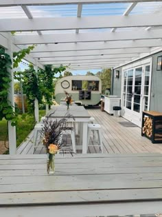 a table and chairs on a wooden deck with an rv in the backgroud