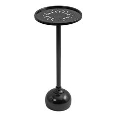 a black table with a metal base and an open hole in the center, on a white background