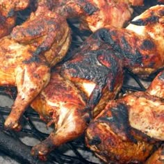 chicken and other meats cooking on a grill