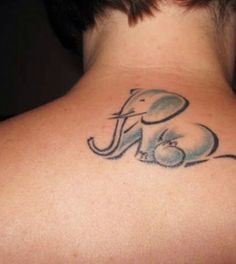 an elephant tattoo on the back of a woman's neck