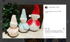 three knitted snowmen sitting on top of a table next to a christmas tree