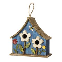 a blue birdhouse with flowers painted on it