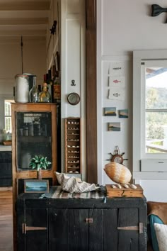 a living room filled with furniture and lots of clutter on top of a wooden table