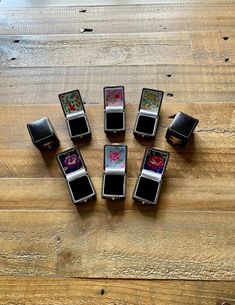 six square rings sitting on top of a wooden table