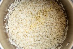 white rice in a silver pot on top of a stove