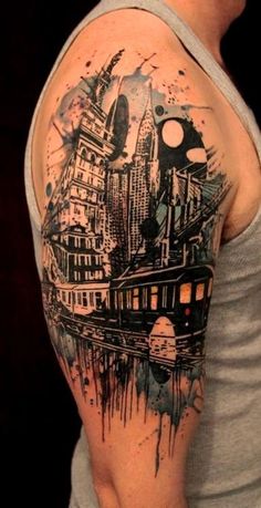 a man's arm with a cityscape on it and a train in the background