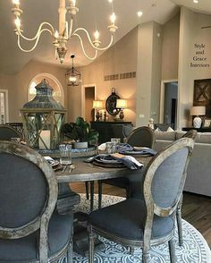 a dining room table with chairs and a chandelier