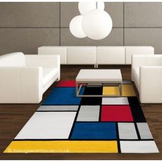 a modern living room with white furniture and colorful rug