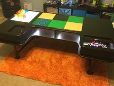 a black table sitting on top of an orange rug