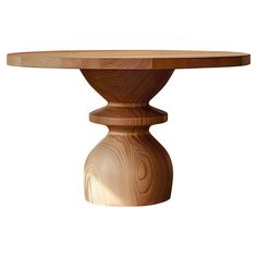 a wooden table with a circular top on it's pedestal base, made out of wood