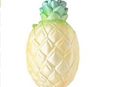 a glass pineapple is sitting on a white background with an orange and green border