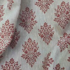 a red and white fabric with small leaves on it