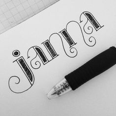 a pen sitting on top of a piece of paper with the word janen written in cursive writing