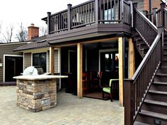 a patio with stairs leading up to an outdoor kitchen