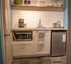 a kitchen with a microwave, sink and dishwasher in it's center