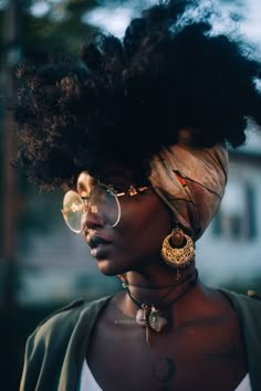 a woman with an afro wearing glasses