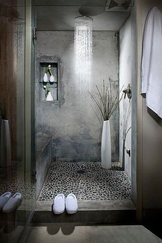 a bathroom with a shower, toilet and towels