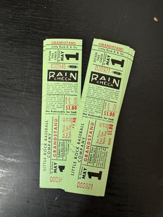 two green train tickets sitting on top of a table