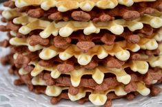 a stack of waffles with white and brown toppings